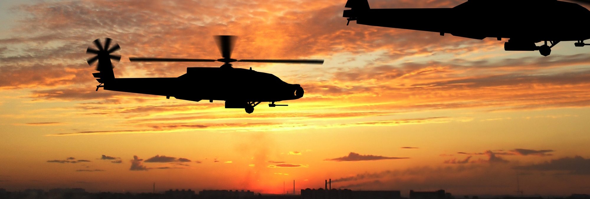 Three helicopters in Iraq over sunset
